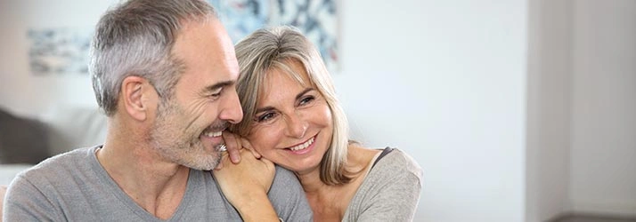 Chiropractic Traverse City MI Hero VA Happy adult couple with grey clothes